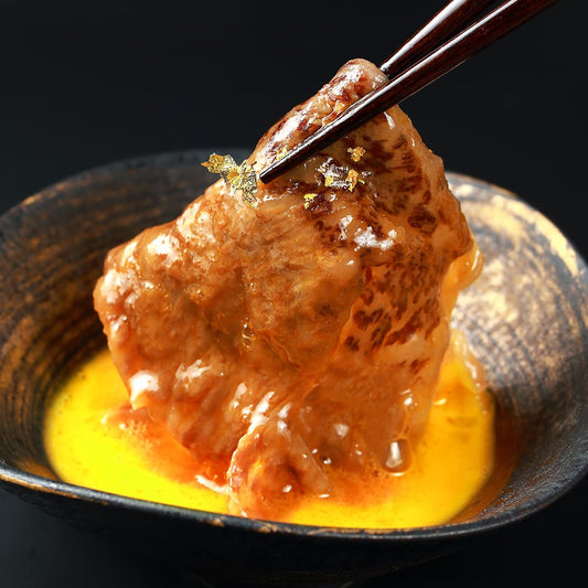 すき焼きにした肩ロースを箸でつまみ上げる場面で、溶き卵をまとった肉から濃厚な汁がしたたり落ちている
