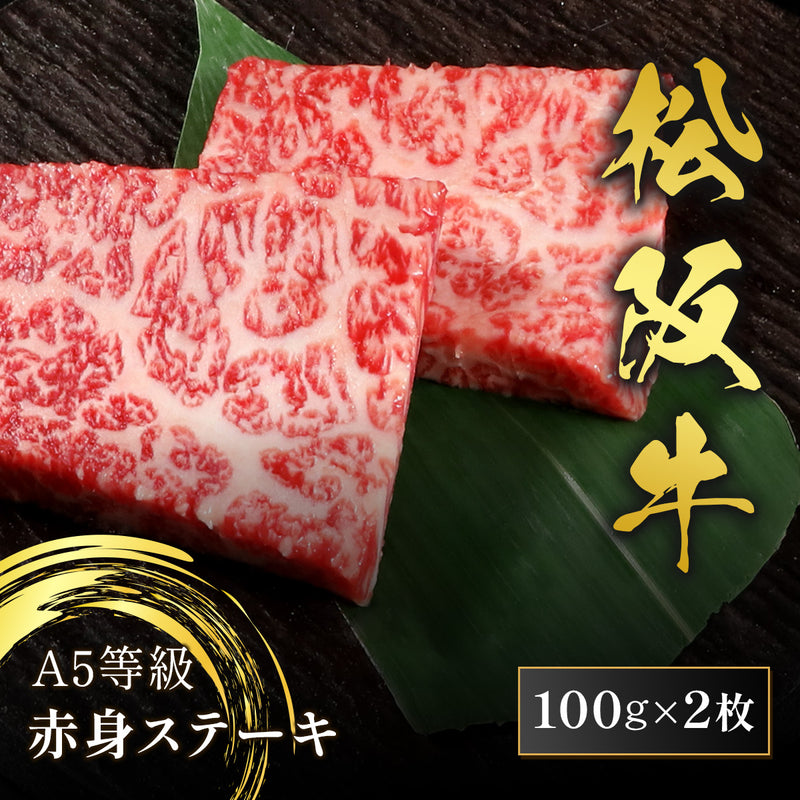 和牛セレブの松阪牛A5等級赤身ステーキ100g×2枚、鮮やかな霜降りと赤身のコントラストが映える2枚の肉が笹の葉の上に並んでいる
